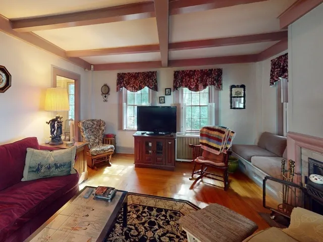 a room with pool table and windows