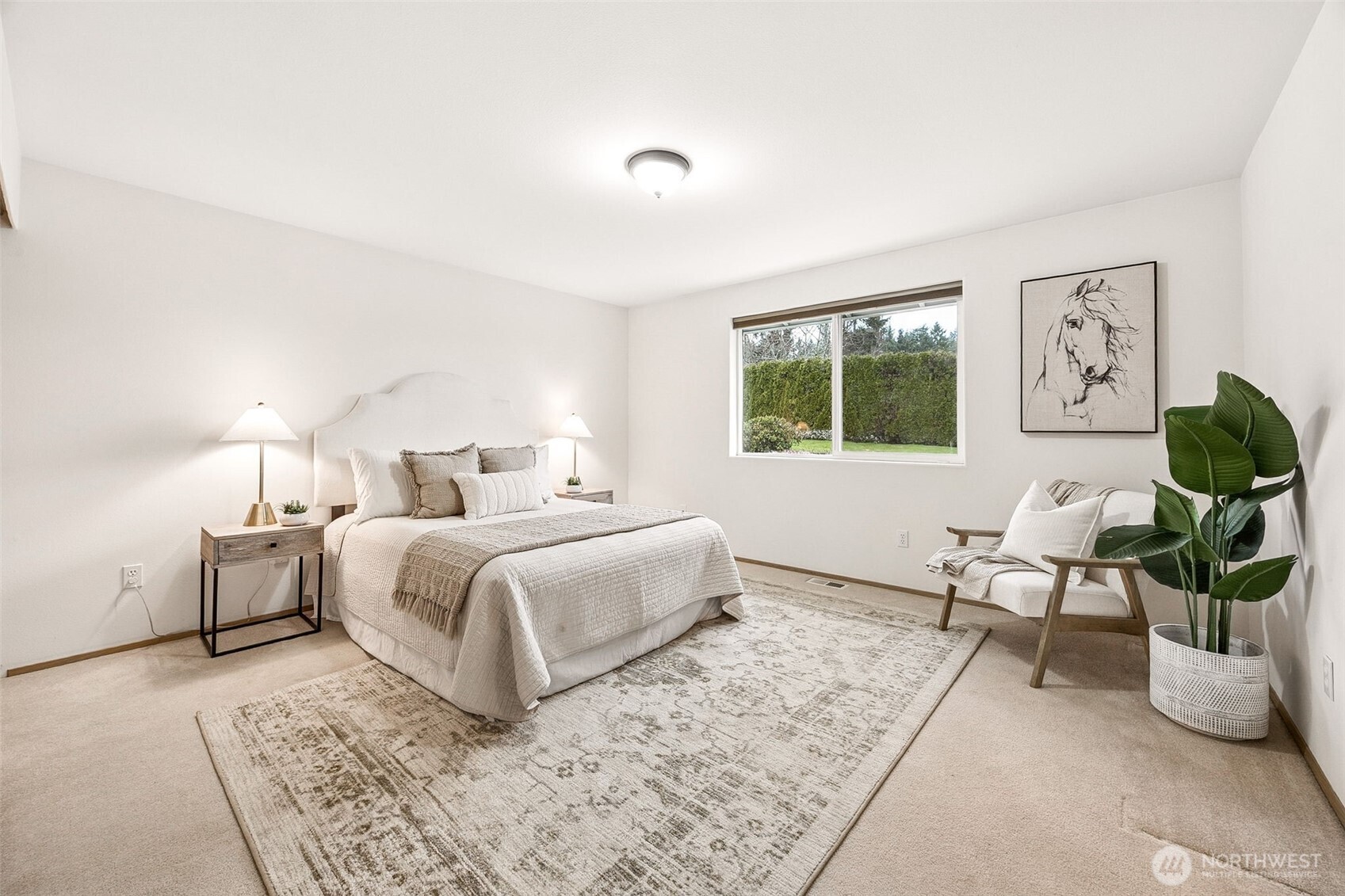 12601 227th Street East Graham, WA 98338 - Photo 18 of 27 a bedroom with a white bed a couch and a window
