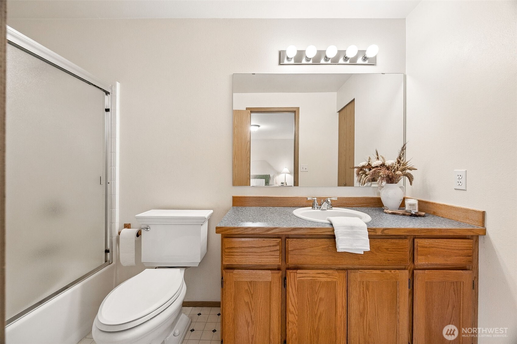12601 227th Street East Graham, WA 98338 - Photo 20 of 27 a bathroom with a granite countertop sink a toilet and a mirror