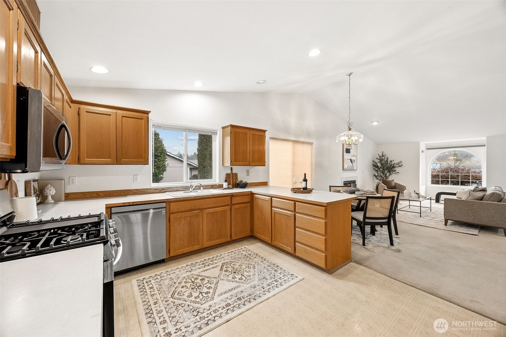 12601 227th Street East Graham, WA 98338 - Photo 21 of 27 a large kitchen with a table and chairs in it