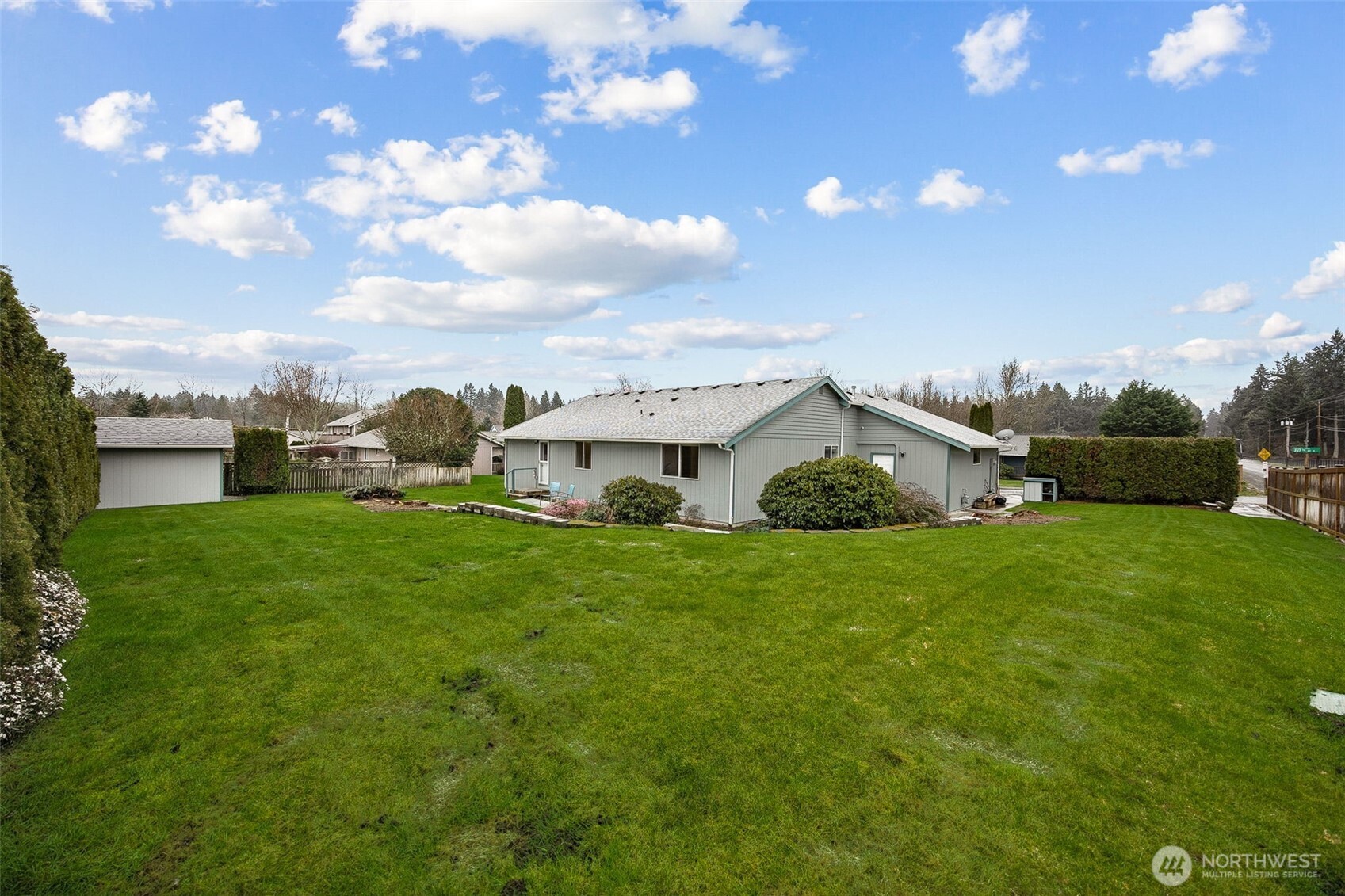 12601 227th Street East Graham, WA 98338 - Photo 22 of 27 a view of a big house with a big yard and a large tree