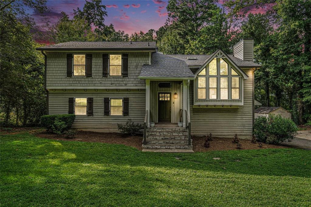 a front view of a house with a garden