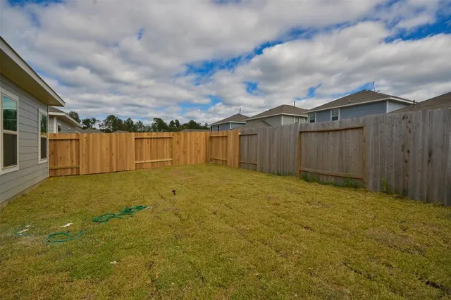 a view of a backyard with large trees