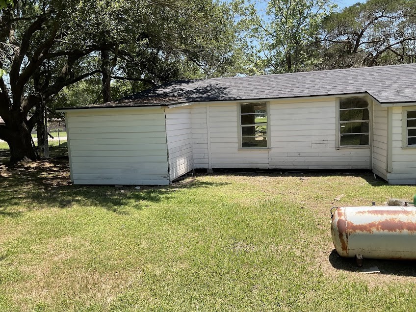 1329 Adams Road Bay City, TX 77414 - Photo 13 of 14 a view of a backyard with plants and a barbeque
