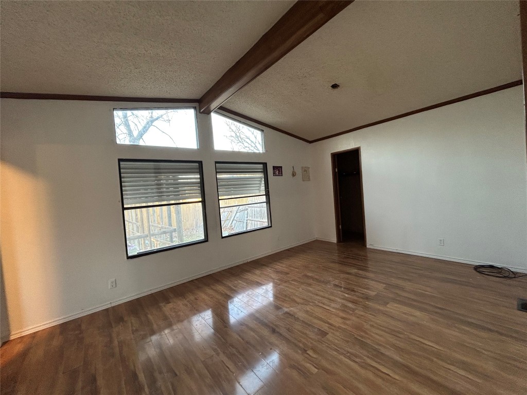 310 E Road Granbury, TX 76049 - Photo 11 of 22 a view of an empty room with wooden floor and a window