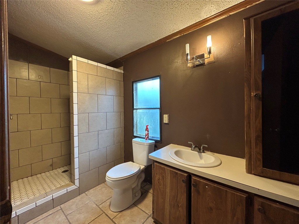 310 E Road Granbury, TX 76049 - Photo 12 of 22 a bathroom with a sink toilet and shower