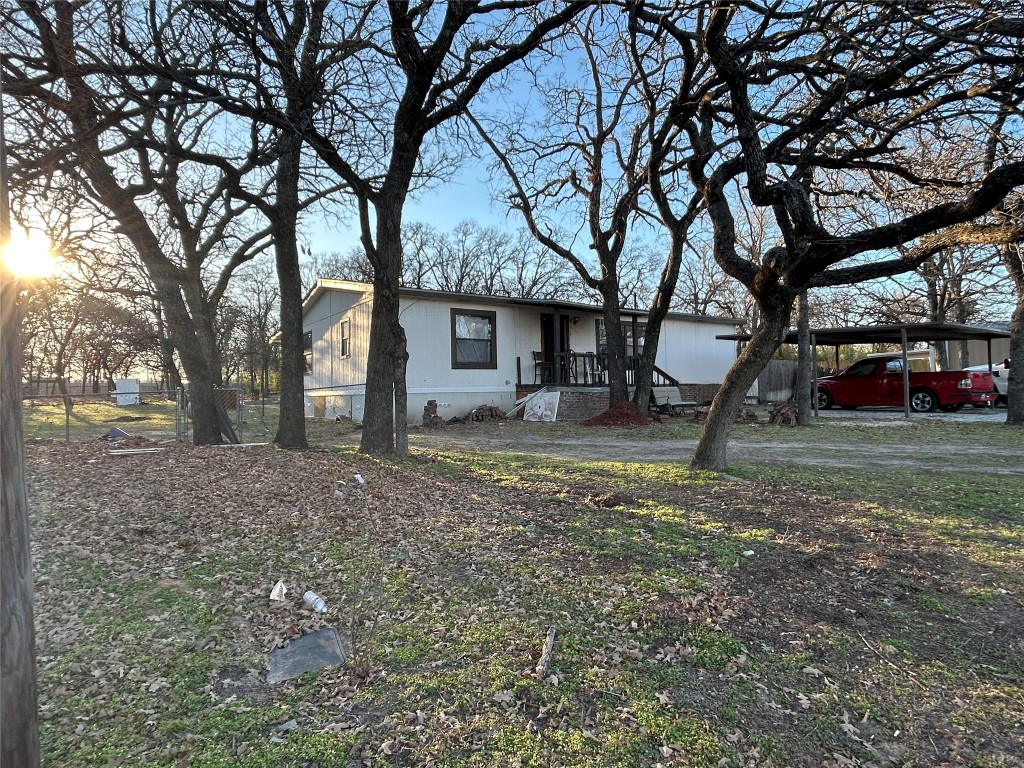 310 E Road Granbury, TX 76049 - Photo 2 of 22 a view of a house with a yard