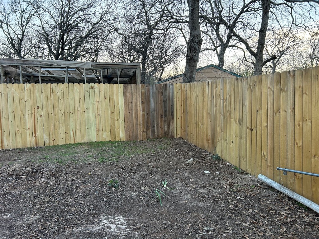 310 E Road Granbury, TX 76049 - Photo 21 of 22 a view of a backyard with wooden fence