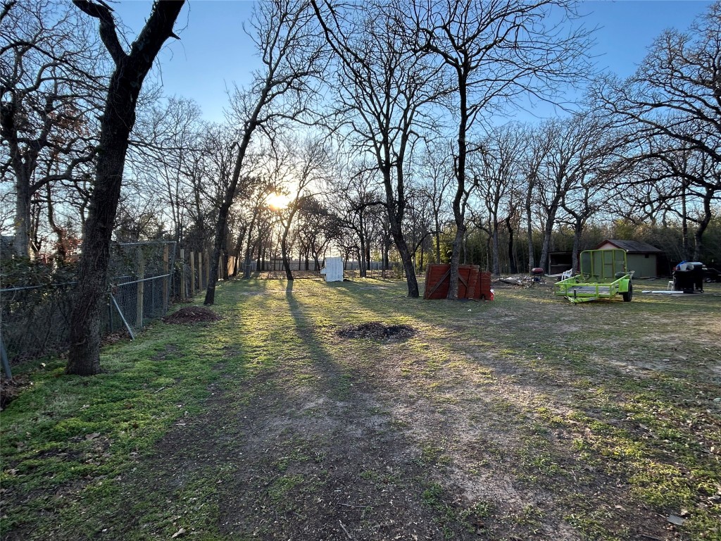 310 E Road Granbury, TX 76049 - Photo 6 of 22 a backyard of apartments with large trees