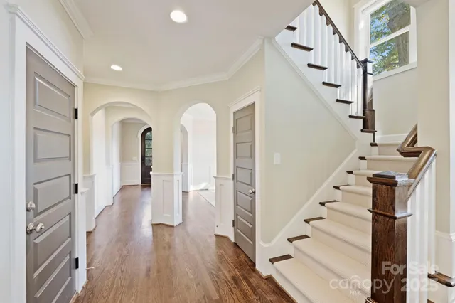a view of entryway with wooden floor and stairs