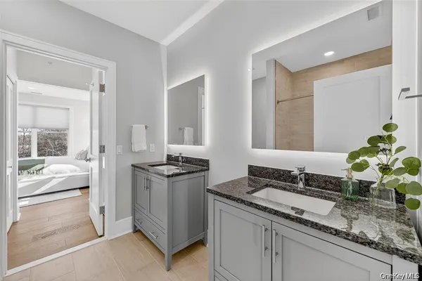 a living room with granite countertop a sink and a stove