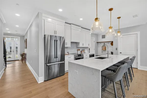 a kitchen with refrigerator cabinets and wooden floor