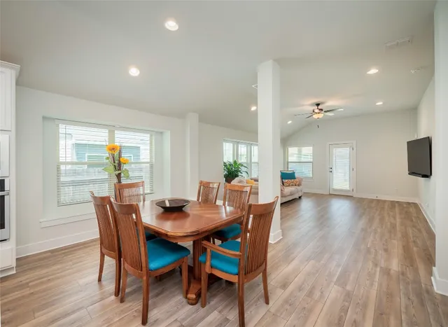 a dining room with furniture and wooden floor