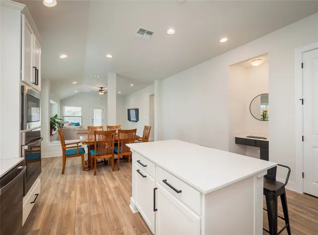 a kitchen with a table chairs and a refrigerator