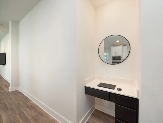 a room with a wooden floor and a mirror