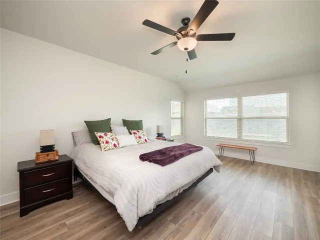 a bedroom with a large bed and a window