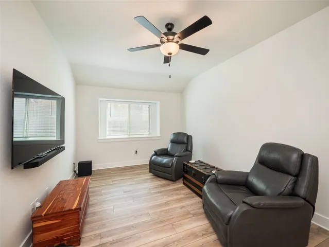a bedroom with furniture and a flat screen tv
