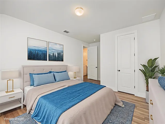 a bedroom with a bed and a painting on the wall