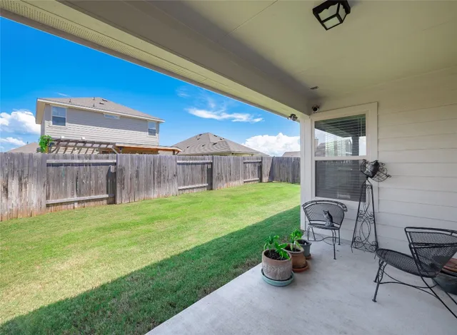 a view of a house with backyard and porch