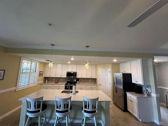 a large kitchen with a table and chairs