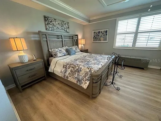 a bed sitting in a bedroom next to a window