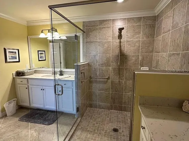 a bathroom with a granite countertop sink a toilet and shower