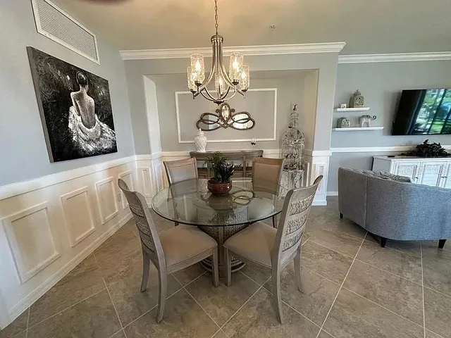 a view of a dining room with furniture and a chandelier