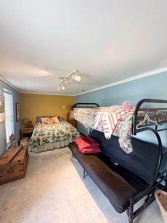 a bedroom with bed and window