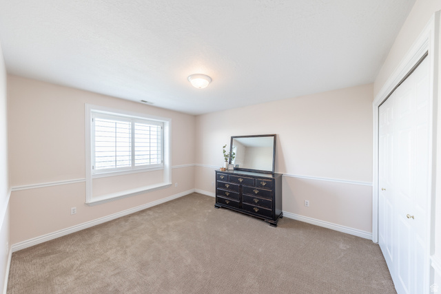 144 Bountiful Boulevard Bountiful, UT 84010 - Photo 21 of 28 Unfurnished bedroom with light carpet and a closet