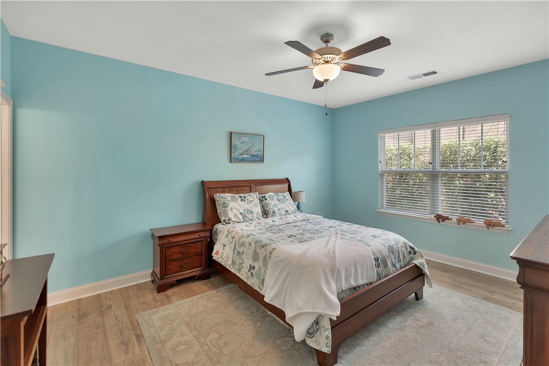 121 Ventura Street Anderson, SC 29621 - Photo 18 of 32 Hardwood floors and a ceiling fan create a comfortable atmosphere in this well-lit sleeping area.