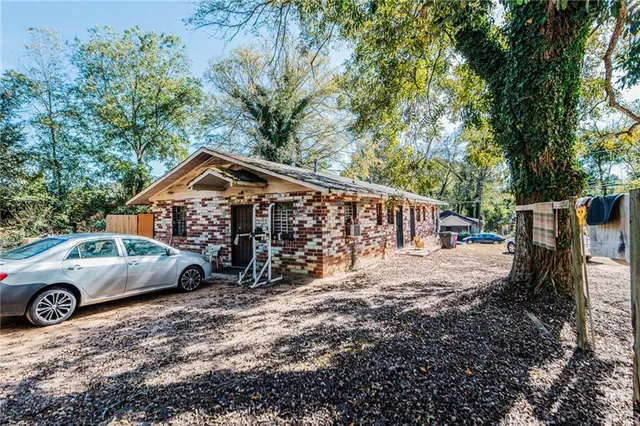 a view of a house with truck parked on a road