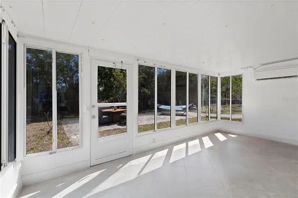 a view of a house with backyard porch and sitting area