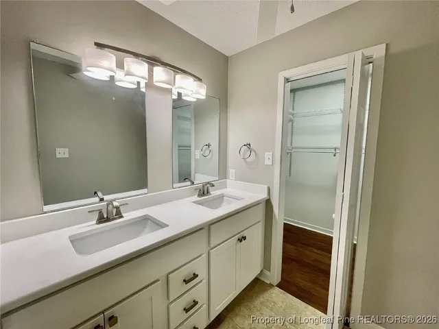 an empty room with a window and ceiling fan