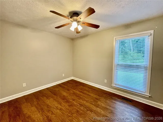 a view of a room with wooden floor