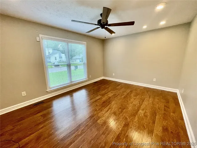 a view of a balcony with wooden floor and fence