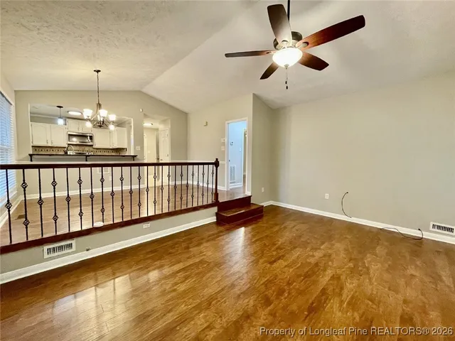 a kitchen with granite countertop a sink and cabinets