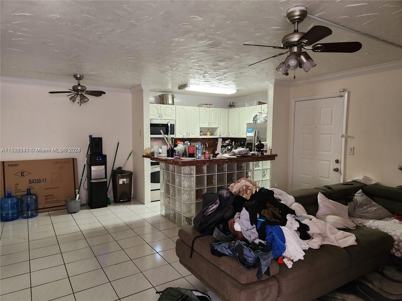 California Club Miami, FL 33179 - Photo 3 of 6 a room with furniture gym equipment and a chandelier