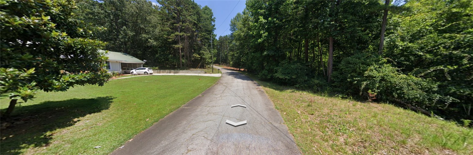 355 Beech Drive Westminster, SC 29693 - Photo 7 of 8 This serene property offers abundant green space and a welcoming front yard, surrounded by lush trees.