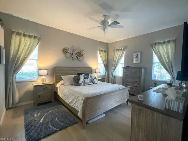a spacious bedroom with a large bed and a chandelier