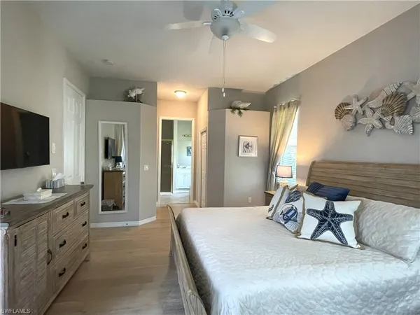 a room with a bed and a flat screen tv