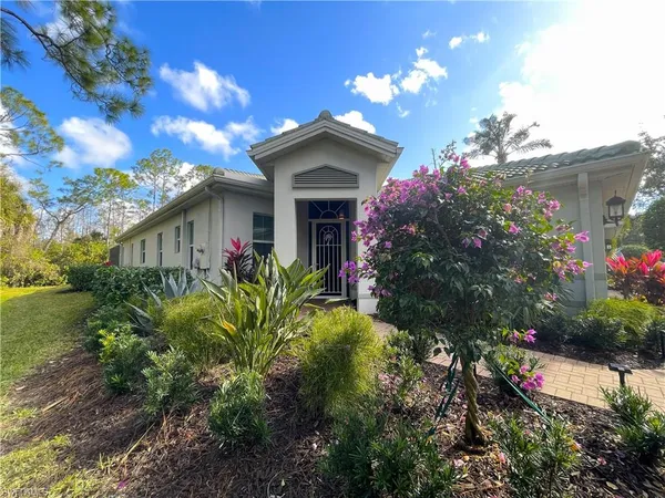 a view of a house with a flower garden