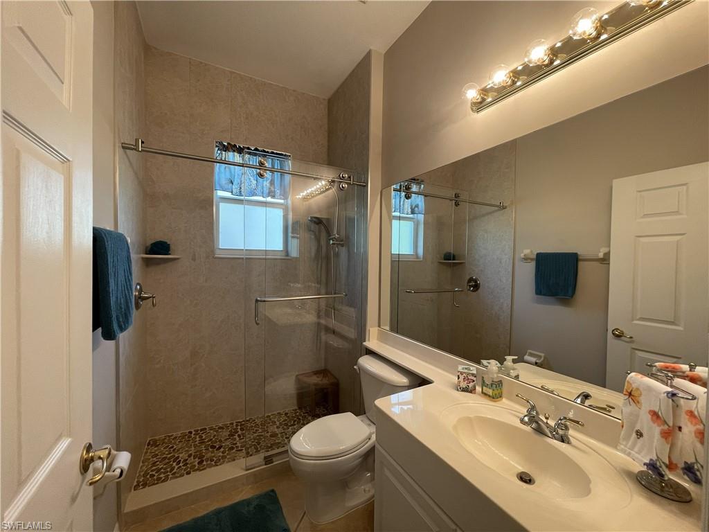 3532 Periwinkle Way, Unit 11 Naples, FL 34114 - Photo 22 of 37 a bathroom with a sink toilet and shower