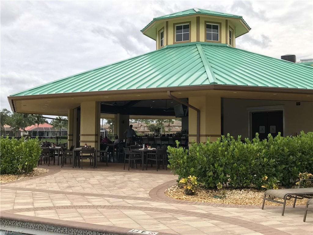 3532 Periwinkle Way, Unit 11 Naples, FL 34114 - Photo 28 of 37 a front view of a house with garden