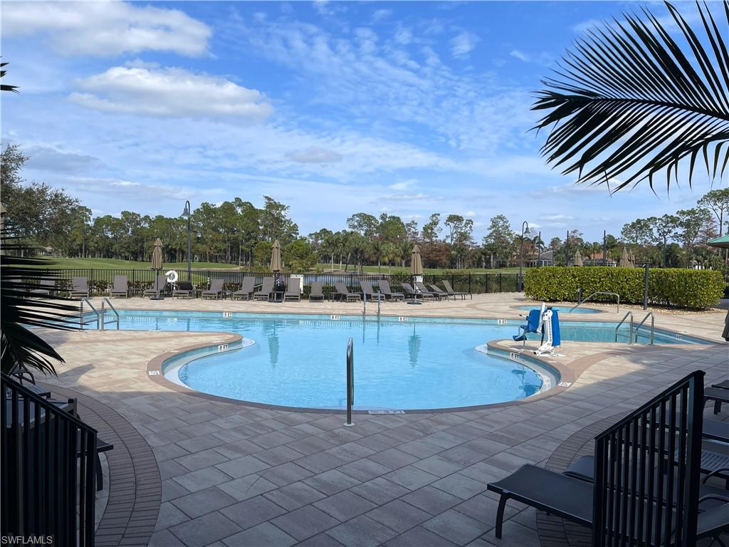 3532 Periwinkle Way, Unit 11 Naples, FL 34114 - Photo 30 of 37 a view of a swimming pool with a terrace