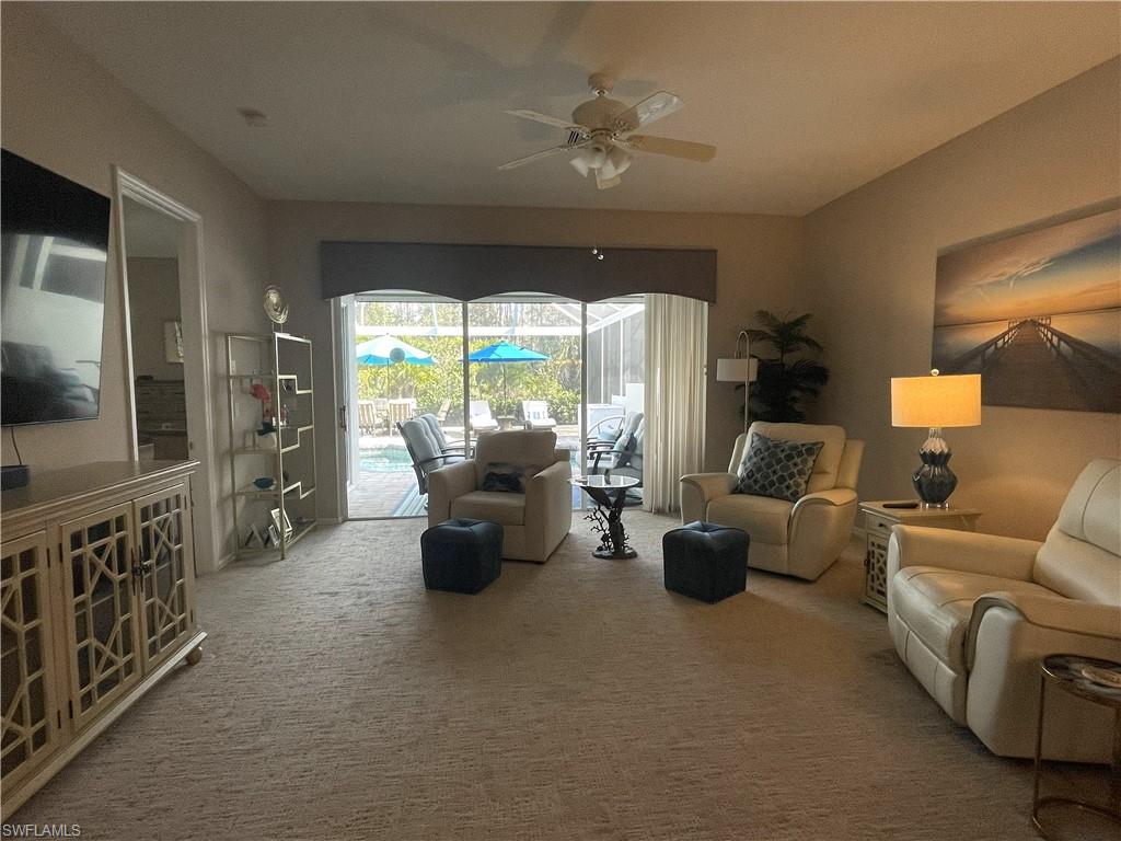 3532 Periwinkle Way, Unit 11 Naples, FL 34114 - Photo 3 of 37 a living room with furniture and a flat screen tv