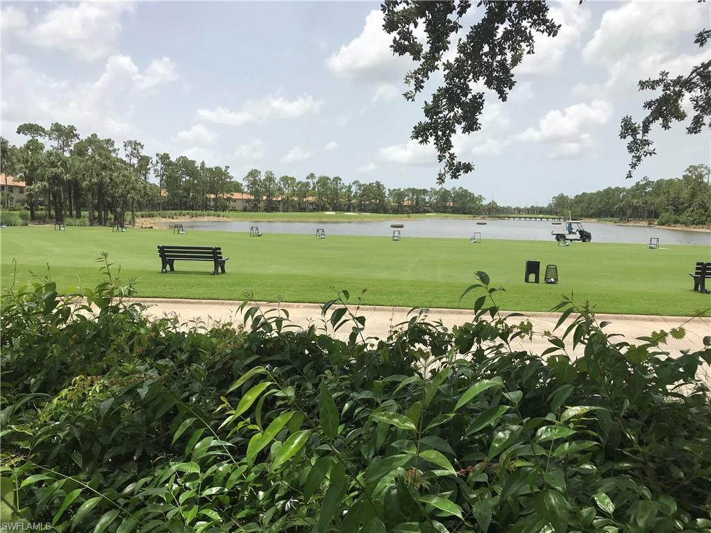 3532 Periwinkle Way, Unit 11 Naples, FL 34114 - Photo 36 of 37 a view of a lake with a big yard and large trees