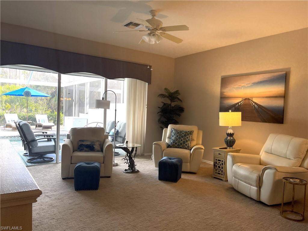 3532 Periwinkle Way, Unit 11 Naples, FL 34114 - Photo 4 of 37 a living room with furniture and a large window