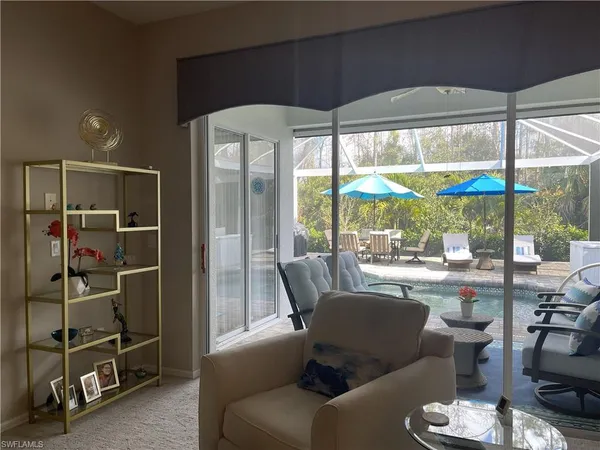 a dining room with furniture water view and a floor to ceiling window