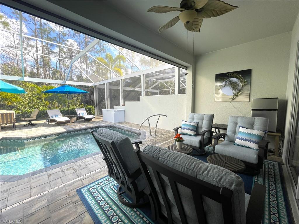 3532 Periwinkle Way, Unit 11 Naples, FL 34114 - Photo 8 of 37 a living room with furniture and a large window