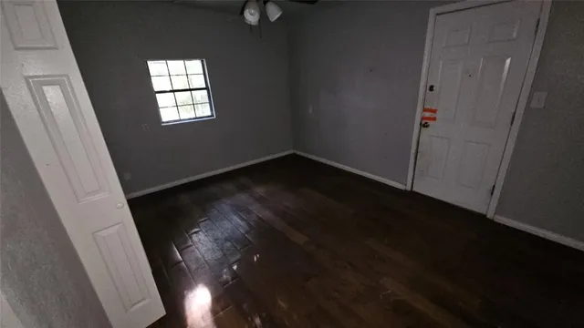 an empty room with wooden floor